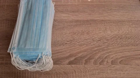  A Medical Professional Puts A Stack Of Antiviral Face Masks On The Table  Stock-Footage 151915023