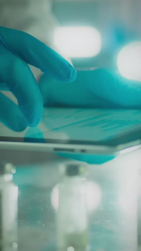 Medical professional uses tablet for data entry in laboratory setting Stock Footage 331667280