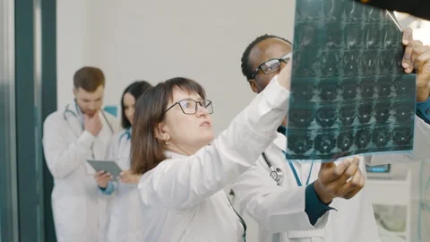Medical professionals analyzing x-ray in lab setting Video stock 276548066