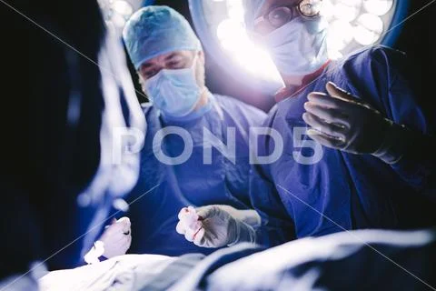 Medical professionals during surgery operating room Stock Photos