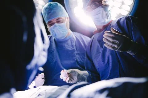Medical professionals during surgery operating room Stock Photos