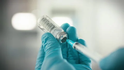 A medical professionals hands clad in protective nitrile gloves meticulously Stock Footage 334075634