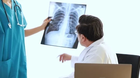 Medical professionals holding x-ray and conversation about patient. Stock Footage 101199348