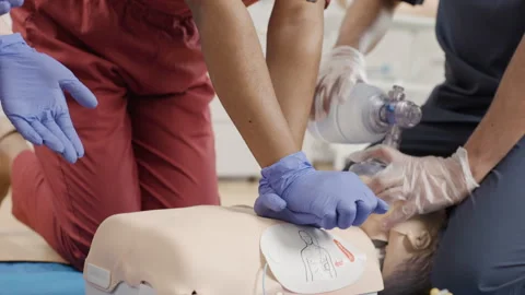 Medical professionals performing first aid procedure on mannequin Video stock 272230569