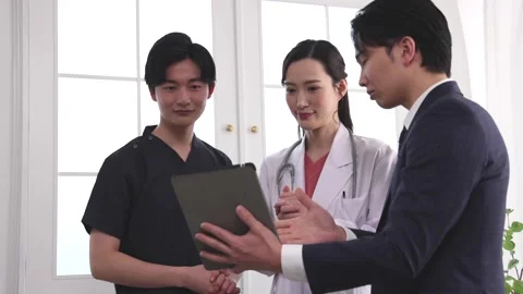 Medical Representative Discussing Information with Doctors Using Tablet 스톡 동영상 344084229
