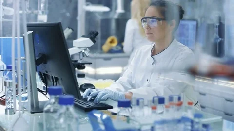 Medical Research Scientist Typing Information on Computer Stock Footage