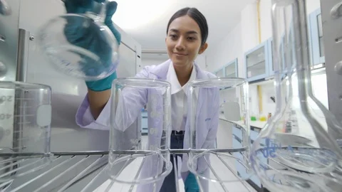 Medical research scientists taking instruments from the sterilisation machine. Stock Footage 94059499