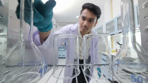 Medical research scientists taking instruments from the sterilisation machine. Video stock 94060871