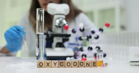 Medical researcher examines Oxycodone through microscope 스톡 동영상 310232746