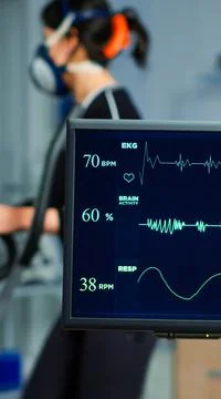 Medical researcher examining EKG image showing on monitor Stock Photos