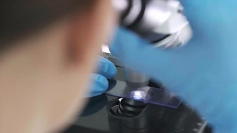 A medical scientist conducts experiments with a microscope Stock Footage 269288447