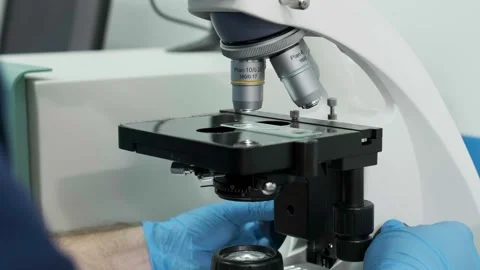 A medical scientist conducts experiments with a microscope Видео 269349772