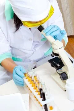 Medical scientist with microscope Stock Photos