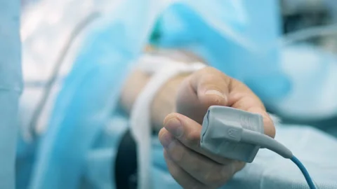 Medical sensor attached to a human hand in a close up Video stock 93276940