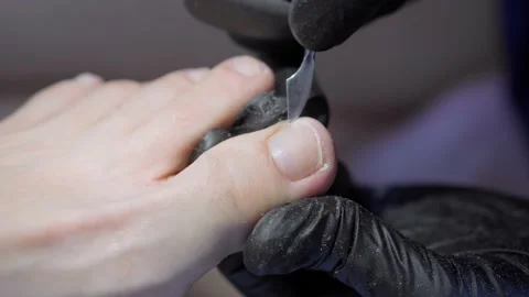 Medical service. Cleaning and processing of the female foot nail. Vídeo Stock 174679658