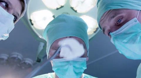 Medical Staff Bent Over the Operating Table Stock Footage 50064074