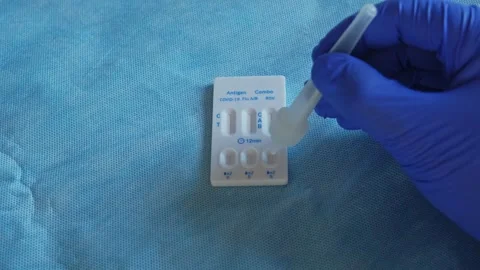 Medical Staff Member Using Quick Antigen Test Cassette for Covid 19 Flu and RSV  Stock Footage 287636636
