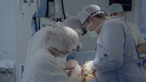 Medical staff of the operating unit do heart surgery. nurse assists in Stock Footage 104922678