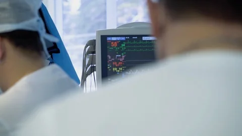 Medical staff of the operating unit do heart surgery. Anesthesiologist observes Stock Footage 104922734