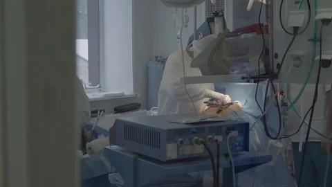 Medical staff of the operating unit do heart surgery. nurse assists in Stock-Footage 104923720