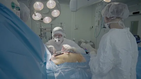 Medical staff of the operating unit do heart surgery. nurse assists in Video stock 104924214