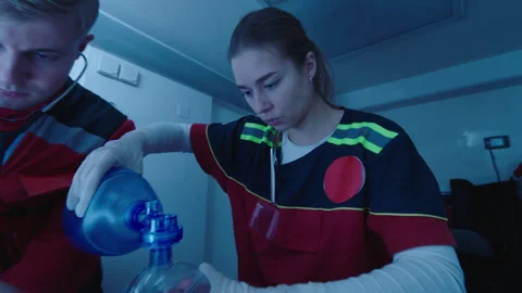 Medical staff performing CPR inside an ambulance and giving oxygen to the Stock Footage 283112931