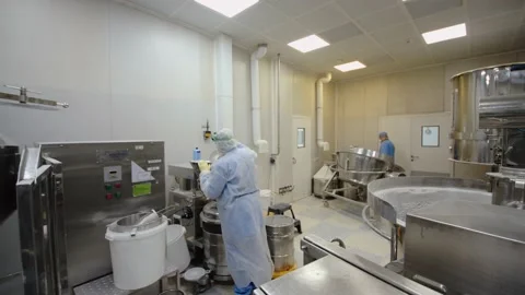 Medical staff in protective uniform work with pharmaceutical facilities at drug Stock Footage 200855221