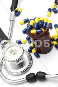 Medical stethoscope and capsule Stock Photos
