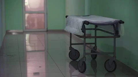 Medical stretcher on wheels standing empty in hospital corridor Stock Footage 195331460