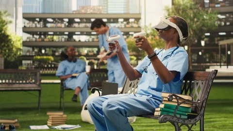 Medical student using VR controllers and headset on wooden bench Stock Footage 340961332