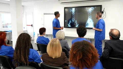 Medical students learning about spinal column x ray in a classroom Stock Footage 331435961
