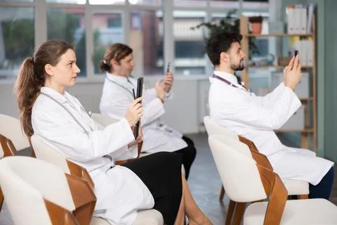 Medical students or doctors using mobile phones to scan QR-code during 스톡 사진