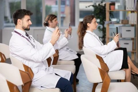 Medical students or doctors using mobile phones to scan QR-code during 스톡 사진