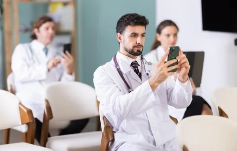 Medical students or doctors using mobile phones to scan QR-code during 스톡 사진