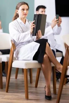 Medical students or doctors using mobile phones to scan QR-code during Stock Photos