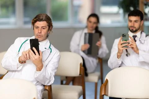 Medical students or doctors using mobile phones to scan QR-code during Stock Photos