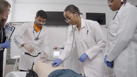 Medical students practice CPR and first aid techniques under supervision Video stock 281363210
