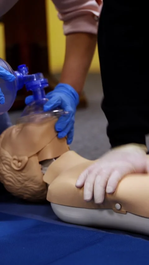 Medical students practicing CPR and ventilation on training mannequin durin.. Stock Footage 337475965