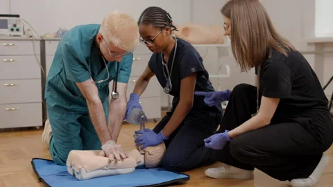 Medical students practicing CPR and resuscitation on a dummy Video stock 347066199
