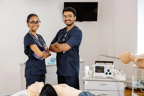 Medical Students Practicing CPR Training with Defibrillator and Mannequin Stock Photos
