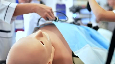 Medical students practicing laparoscopic surgery on a realistic training Stock Footage 323319508