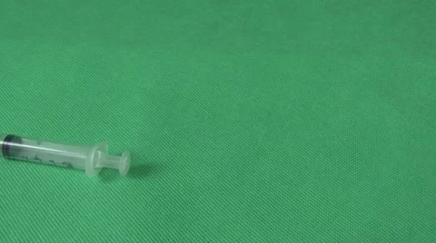 Medical syringes and vials on green background Stock Footage 59120505