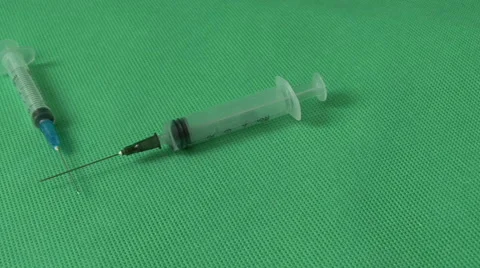 Medical syringes on green background Stock Footage 59121446