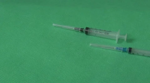 Medical syringes on green background Stock Footage 59121731