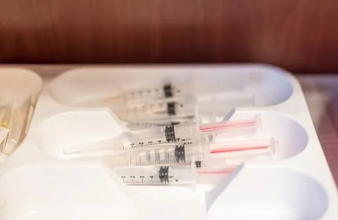 Medical syringes prefilled with saline solution Stockfoto's