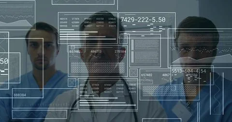 Medical team analyzing translucent data panels in hospital corridor, showing Foto stock