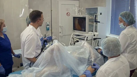 Medical team conducting surgery using endoscope Vídeos de archivo 77363643