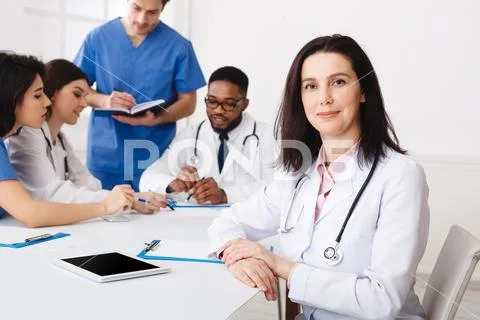 Medical Team Conference. Female Practitioner At Meeting Stock Photos