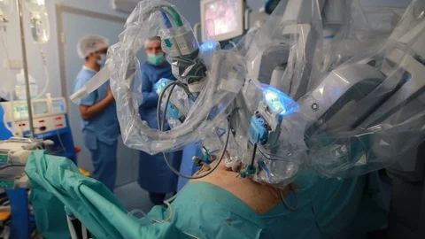 Medical team with doctors using robotic surgery robot in surgical room in hos 動画素材 102186596