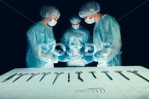 Medical Team Hospital Performing Operation. Group Of Surgeon At Work In
